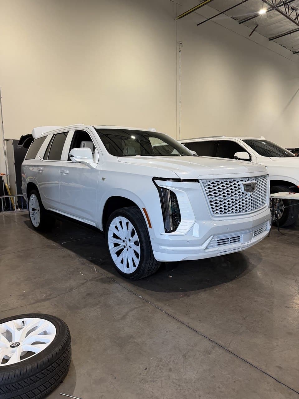 All-white Cadillac Escalade full vehicle wrap in Purple Flare Wraps shop serving Summerlin Las Vegas