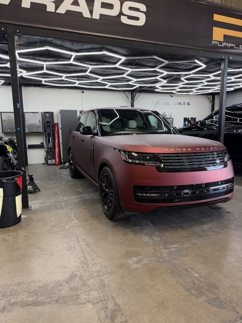Matte burgundy Range Rover color change wrap under hex lights at Purple Flare Wraps Las Vegas