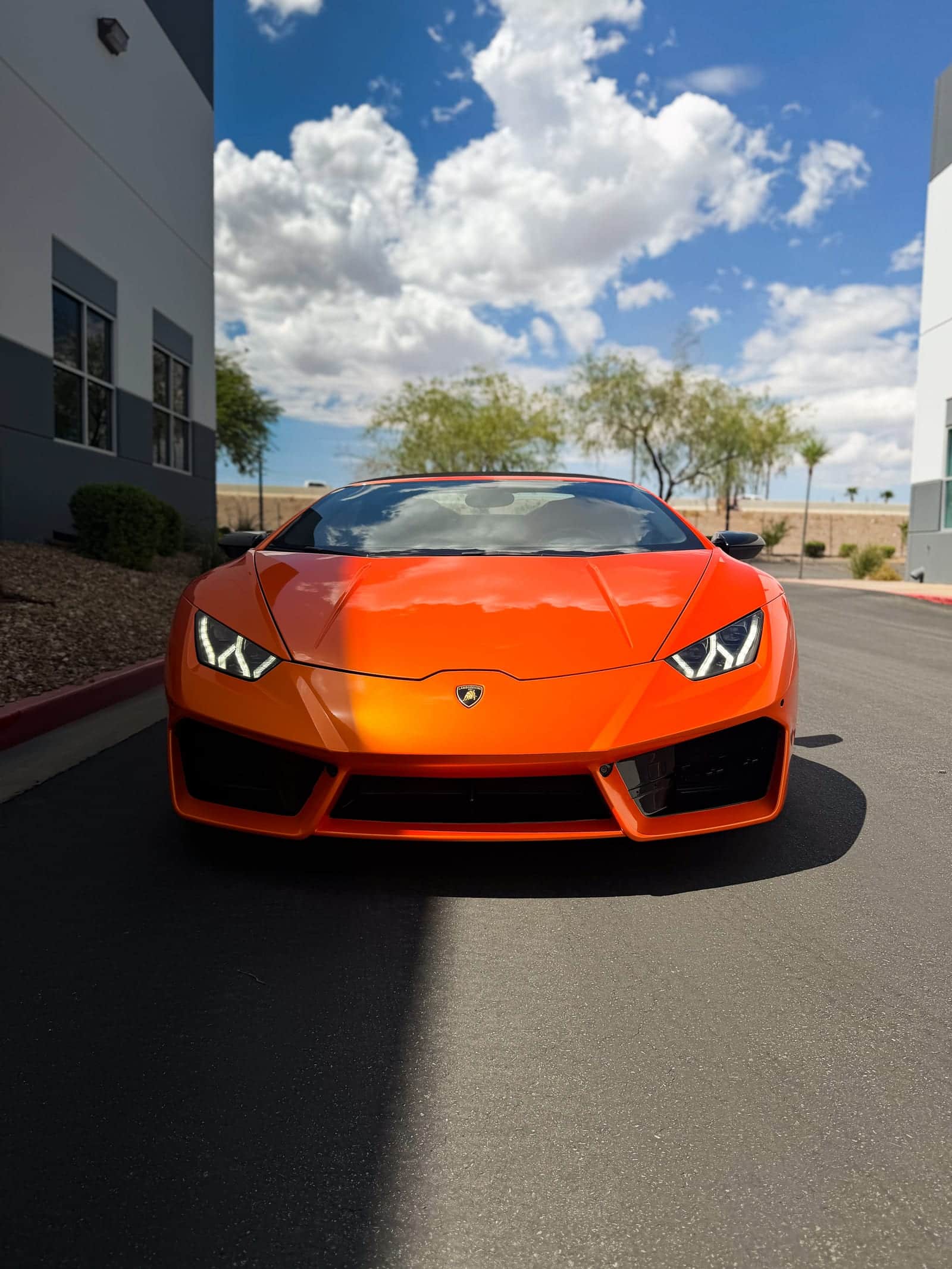orange car wrap — head-on front view of the gloss orange wrapped Lamborghini Huracan